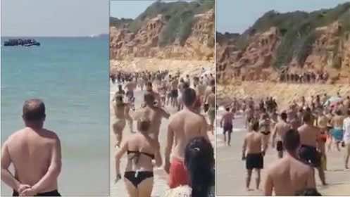 أزمة الهجرة تشتد.. قارب مهاجرين يفاجئ المصطافين في شاطئ إسباني - فيديو
